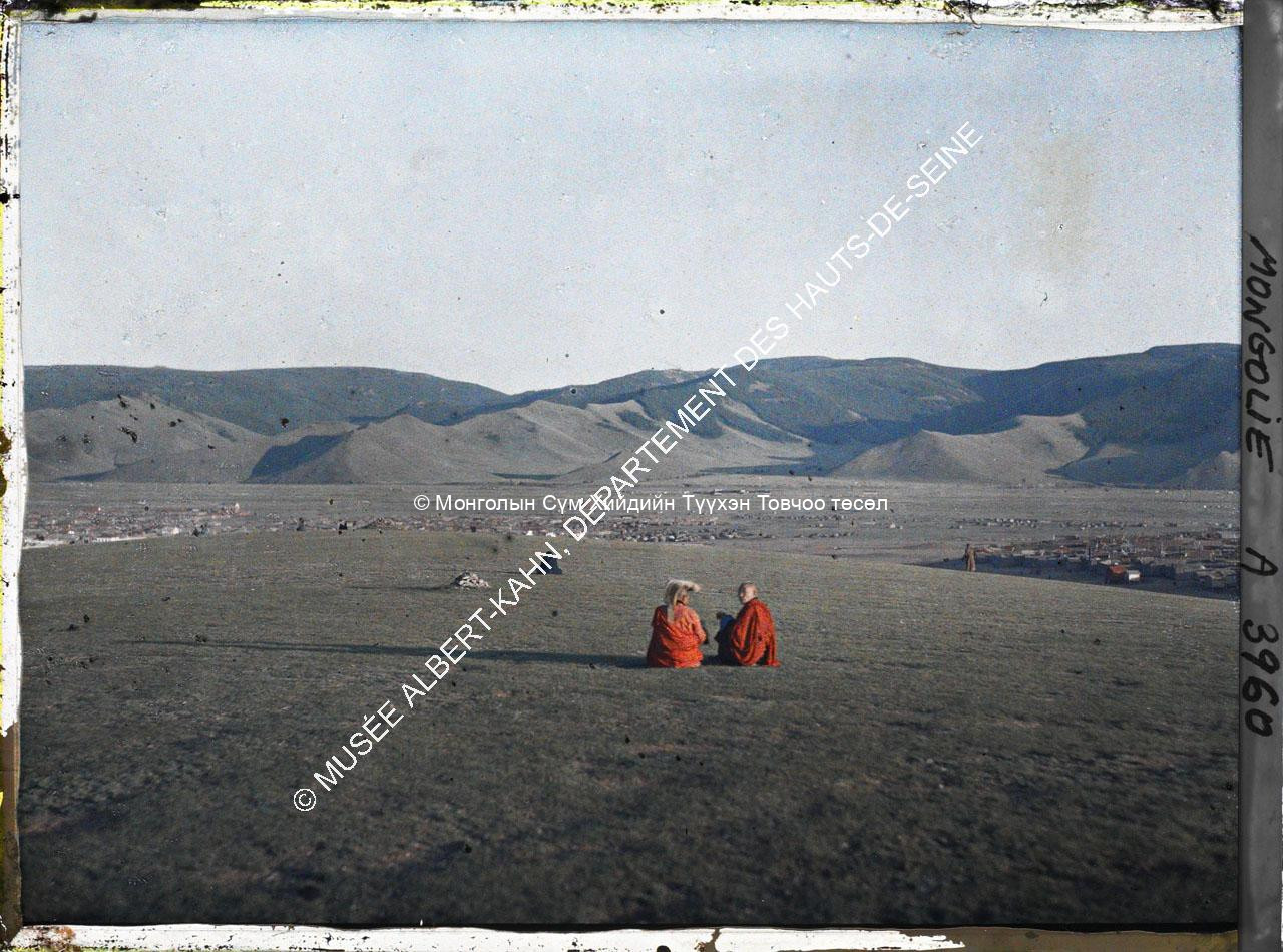 Monks sitting at Tasganii ovoo between Züün khüree and Gandan. Musée Albert-Kahn. A3960. Photo by Stéphane Passet. 23 July, 1913